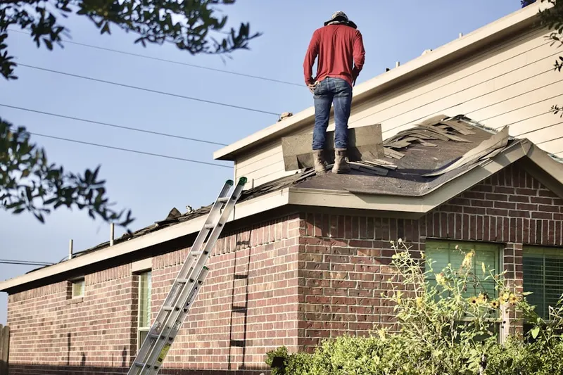 Professional roofer working on a residential roof in Jerrehian Estates